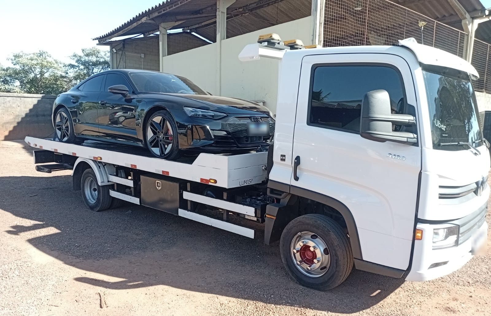 Guincho plataforma transportando um carro